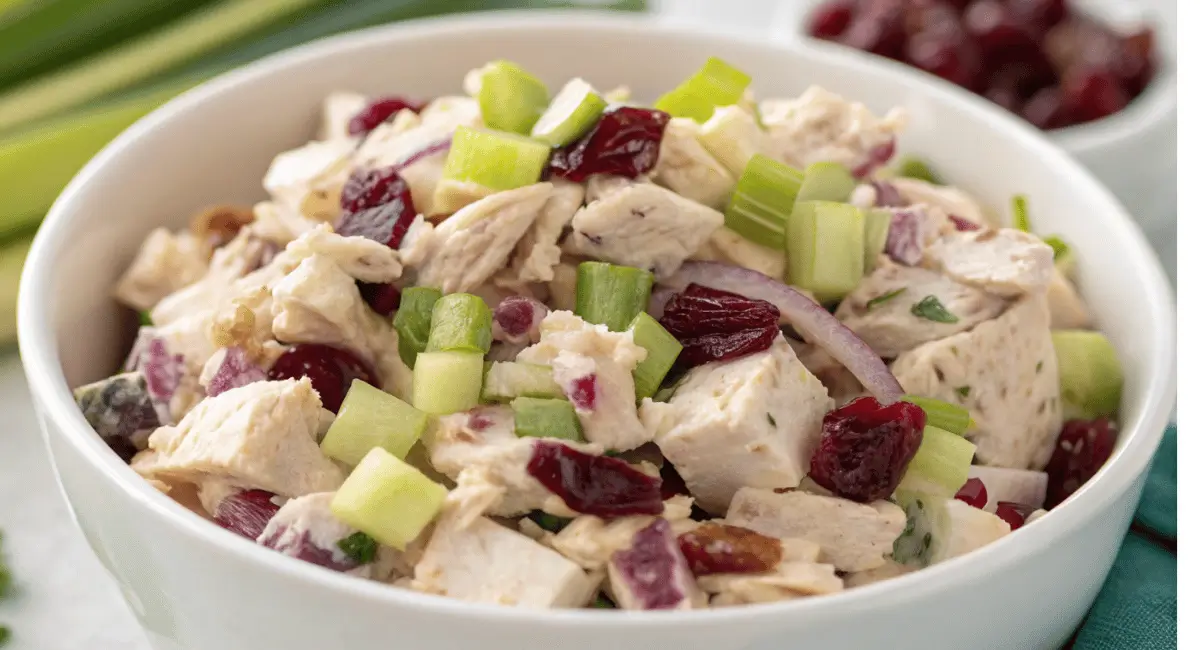 A bowl of delicious chicken salad with cranberries and pecans, ready to be served