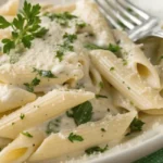 How to Make a Creamy Goat Cheese Pasta Sauce 9 Creamy goat cheese melting into a smooth pasta sauce in a saucepan, showing the perfect texture.