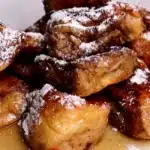 Hawaiian Roll French Toast: Quick & Easy Recipe You'll Love! 9 Completed Hawaiian Roll French Toast, stacked and garnished.