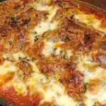 Baked butter bean lasagna in a glass dish, golden brown and bubbly.