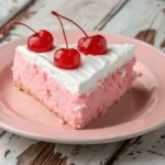 A slice of cherry chip cake recipe with whipped cream and fresh cherries