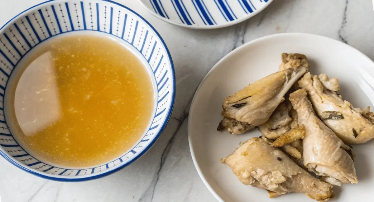 Cooked chicken drumsticks soup and a bowl of broth