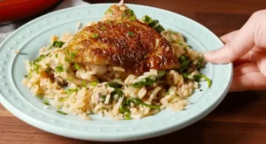 Serving of Ranch Chicken and Rice with crispy chicken and fresh herbs on a light blue plate.