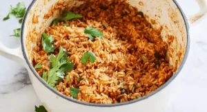 Mexican Brown Rice in a pot, garnished with cilantro.