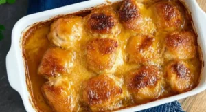 Golden brown and bubbly apricot chicken in a white baking dish, finished apricot chicken recipe baked.